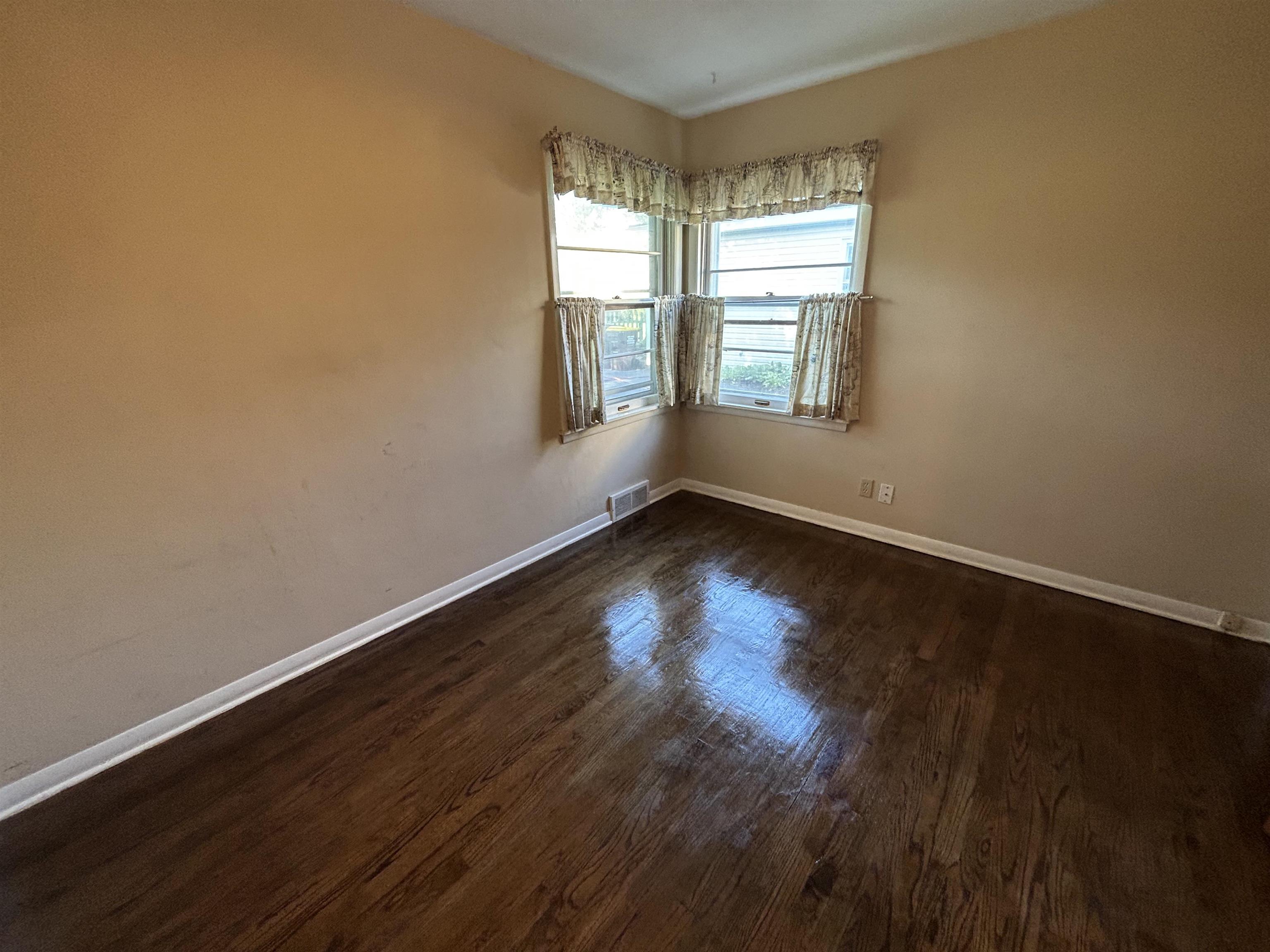 4003 Pinecrest Road Rockford, IL 61107 - Photo 12 of 16 a view of an empty room with wooden floor and a window