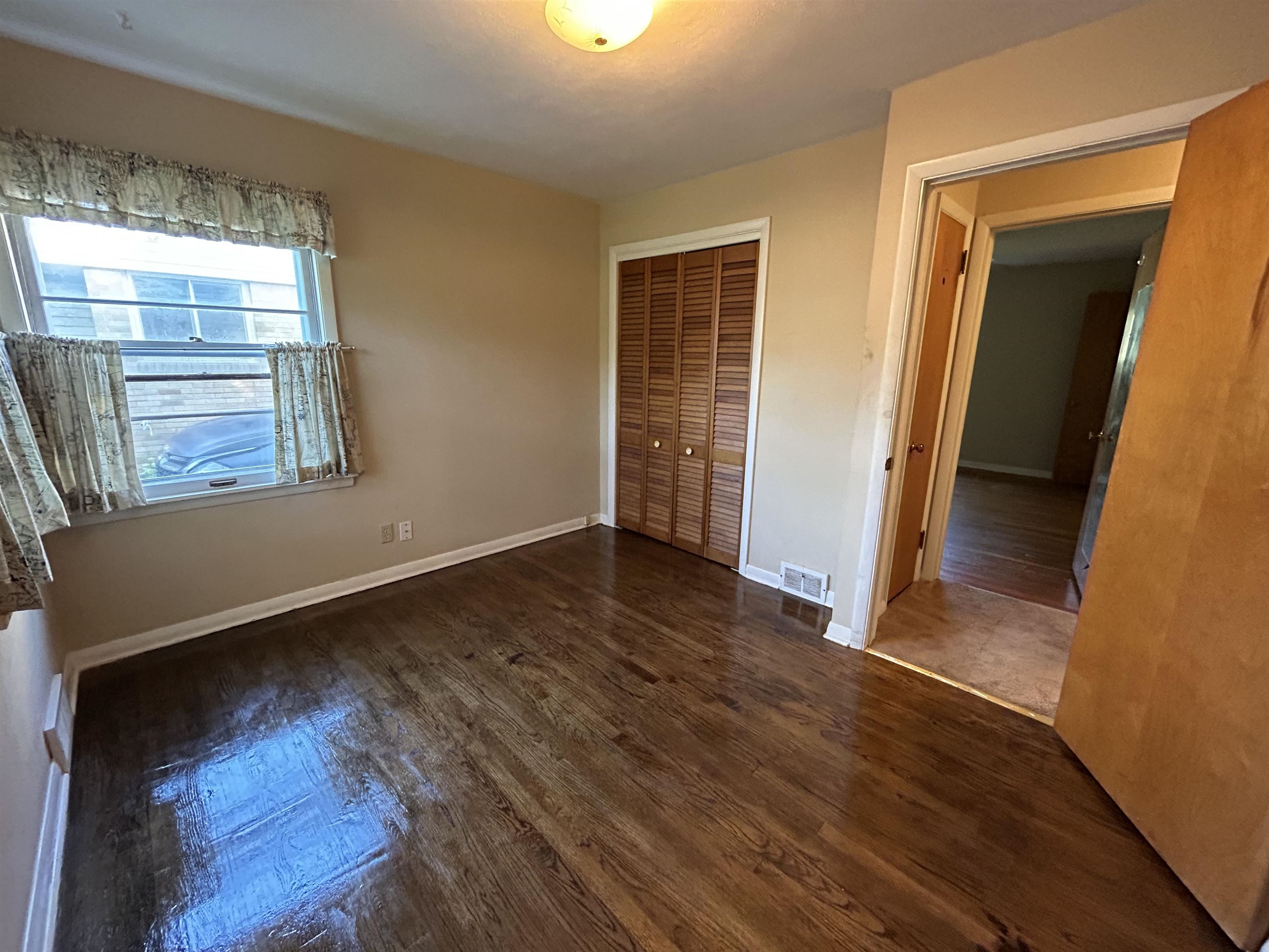 4003 Pinecrest Road Rockford, IL 61107 - Photo 13 of 16 an empty room with wooden floor and windows