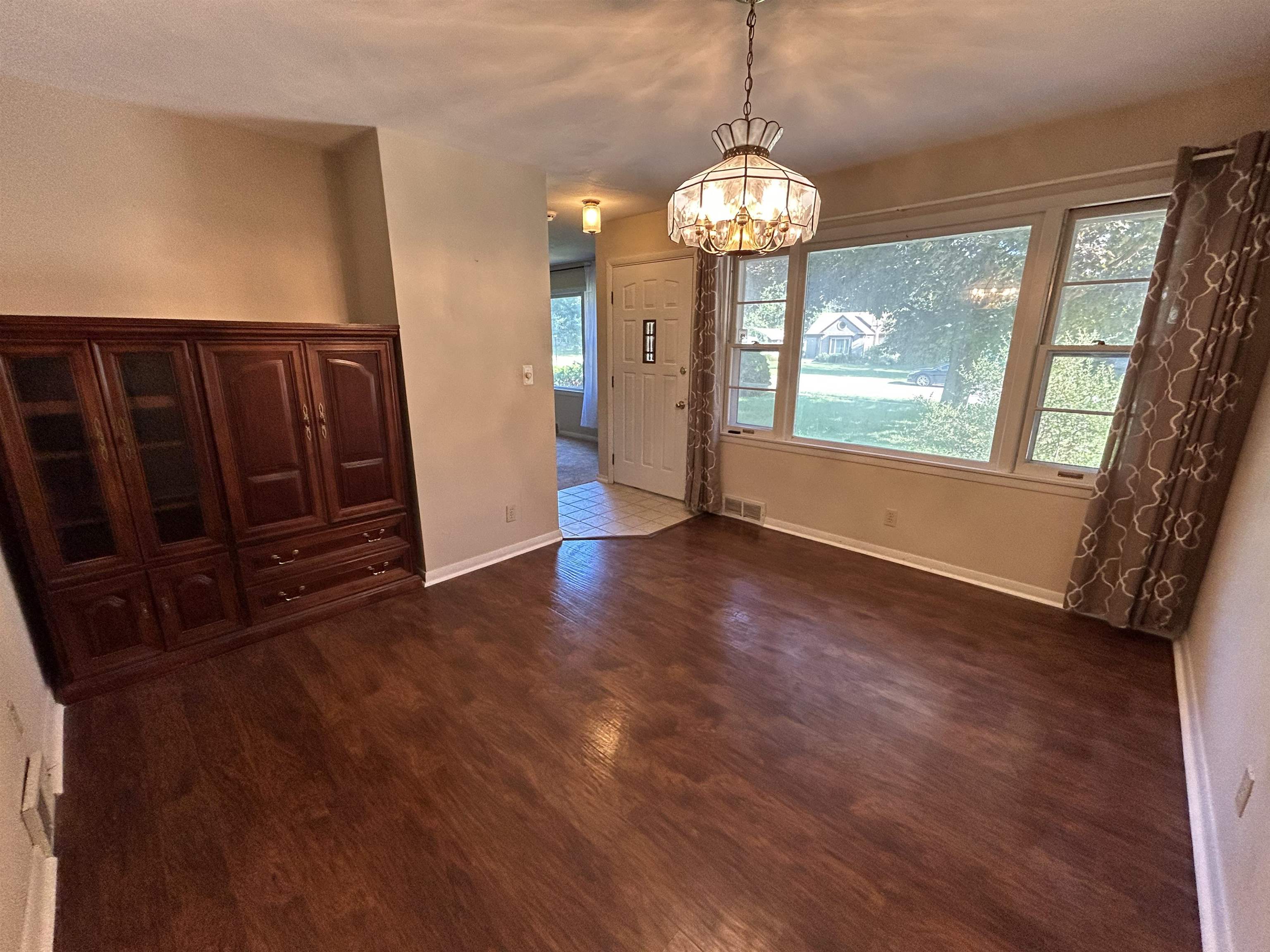 4003 Pinecrest Road Rockford, IL 61107 - Photo 6 of 16 a view of an empty room with wooden floor and a window