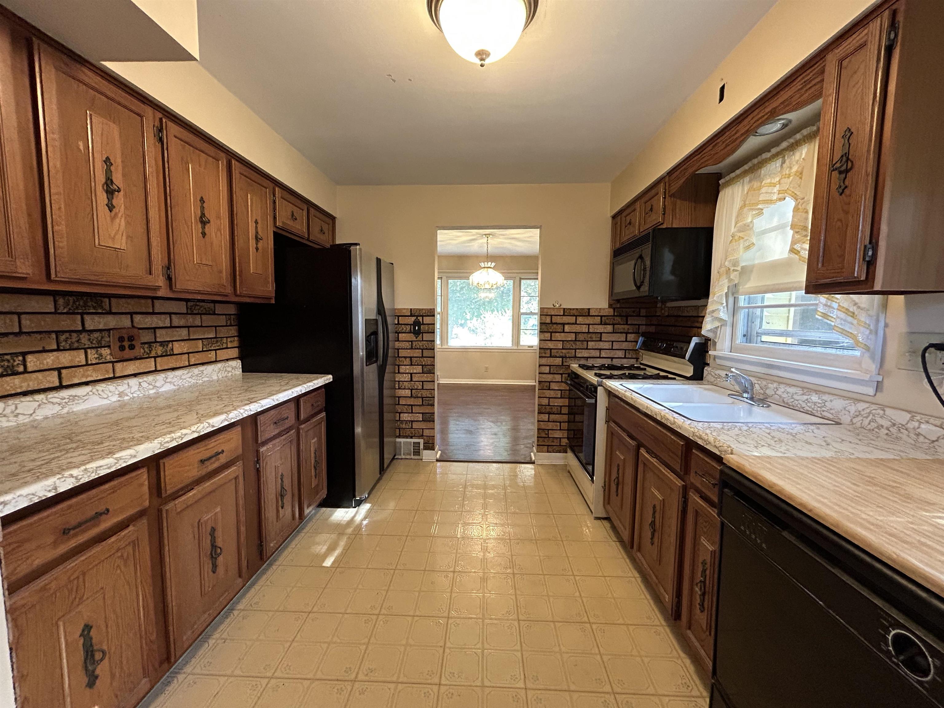 4003 Pinecrest Road Rockford, IL 61107 - Photo 7 of 16 a kitchen with stainless steel appliances granite countertop a sink stove and refrigerator