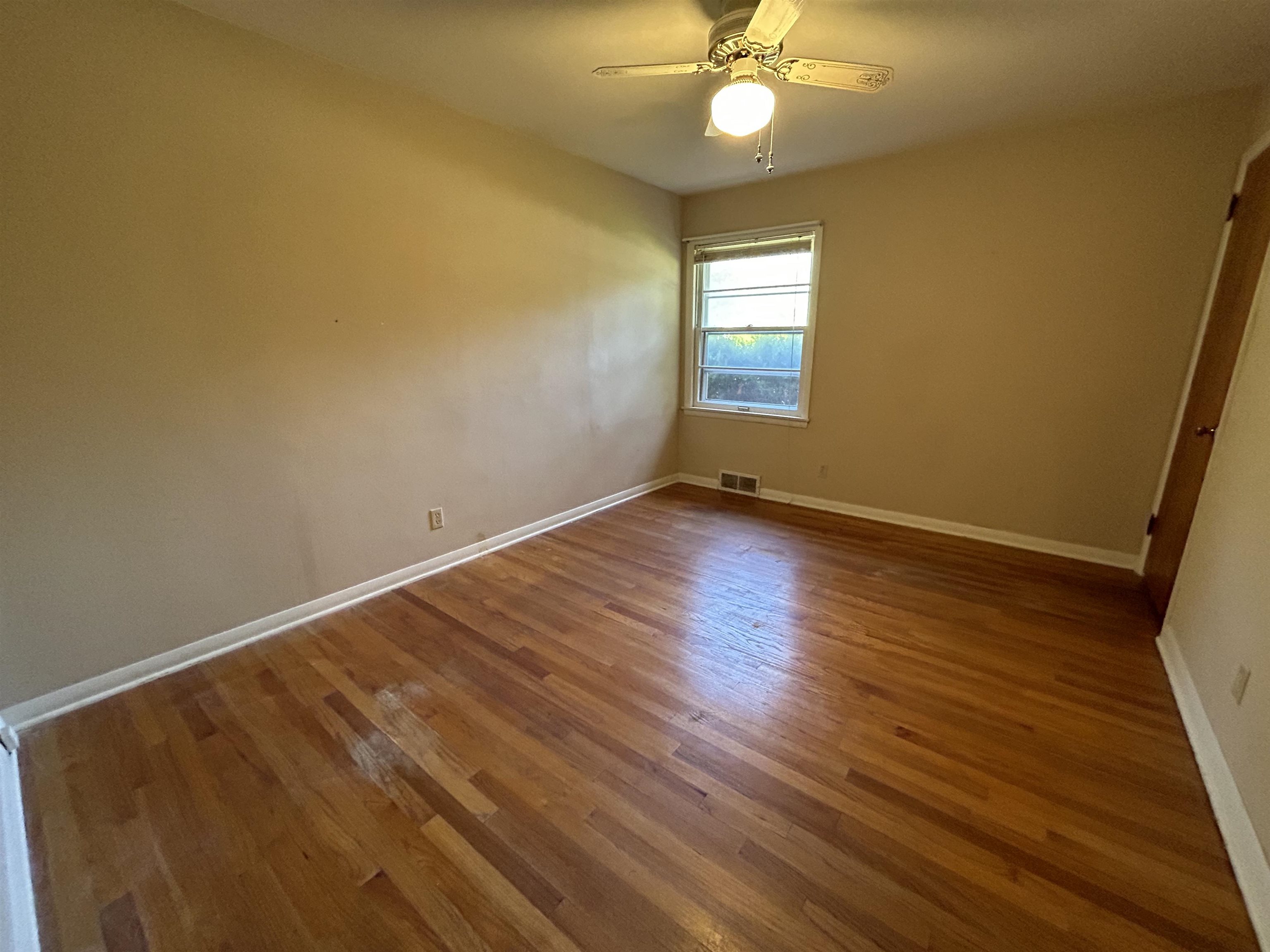 4003 Pinecrest Road Rockford, IL 61107 - Photo 10 of 16 a view of an empty room with wooden floor and a window