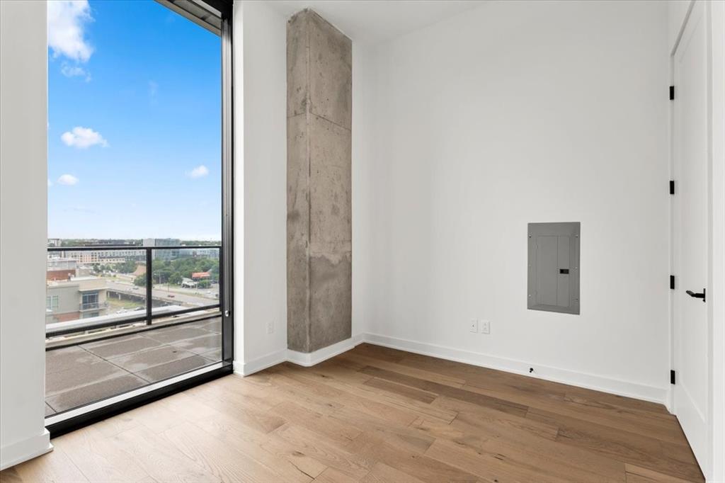 84 East Avenue, Unit 1202 Austin, TX 78701 - Photo 13 of 39 an empty room with wooden floor and windows