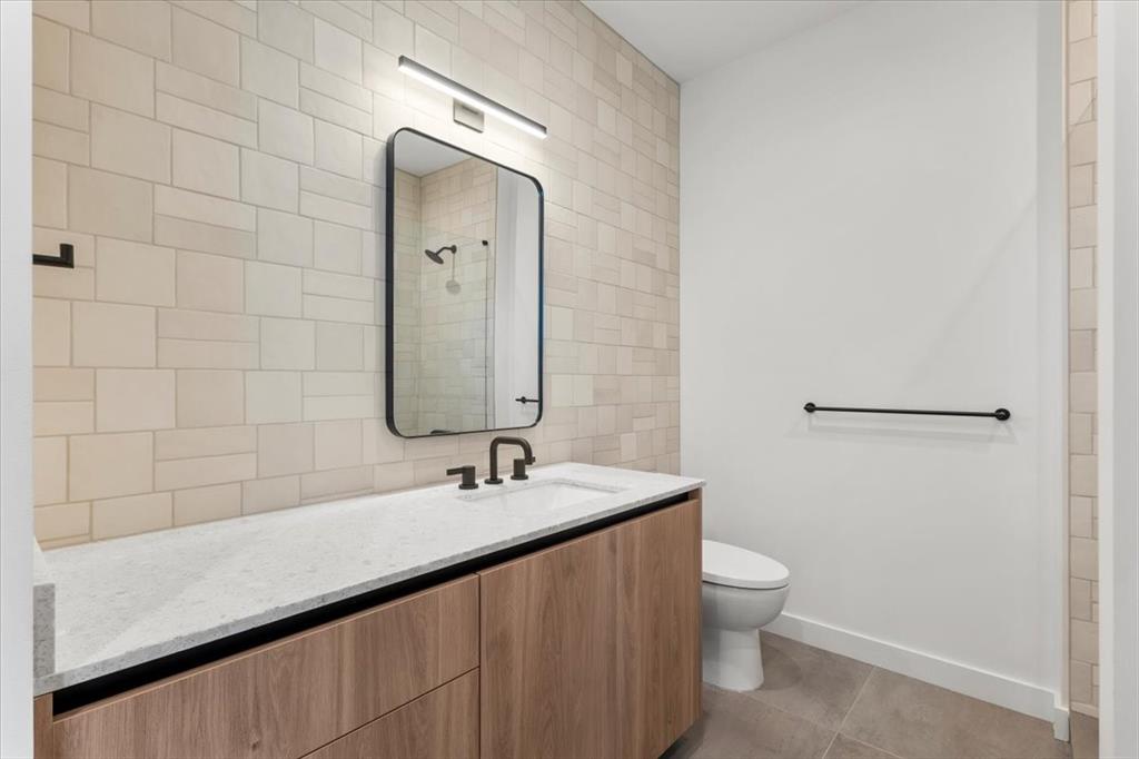 84 East Avenue, Unit 1202 Austin, TX 78701 - Photo 14 of 39 a bathroom with a sink a toilet and shower