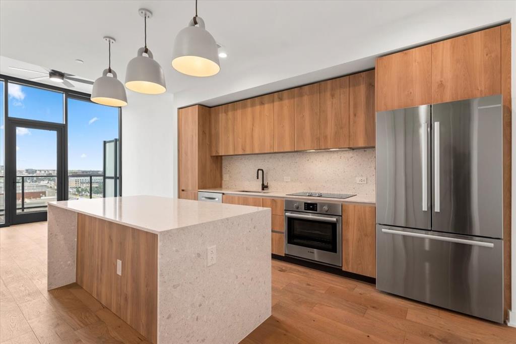 84 East Avenue, Unit 1202 Austin, TX 78701 - Photo 3 of 39 a kitchen with stainless steel appliances a sink a refrigerator and a stove