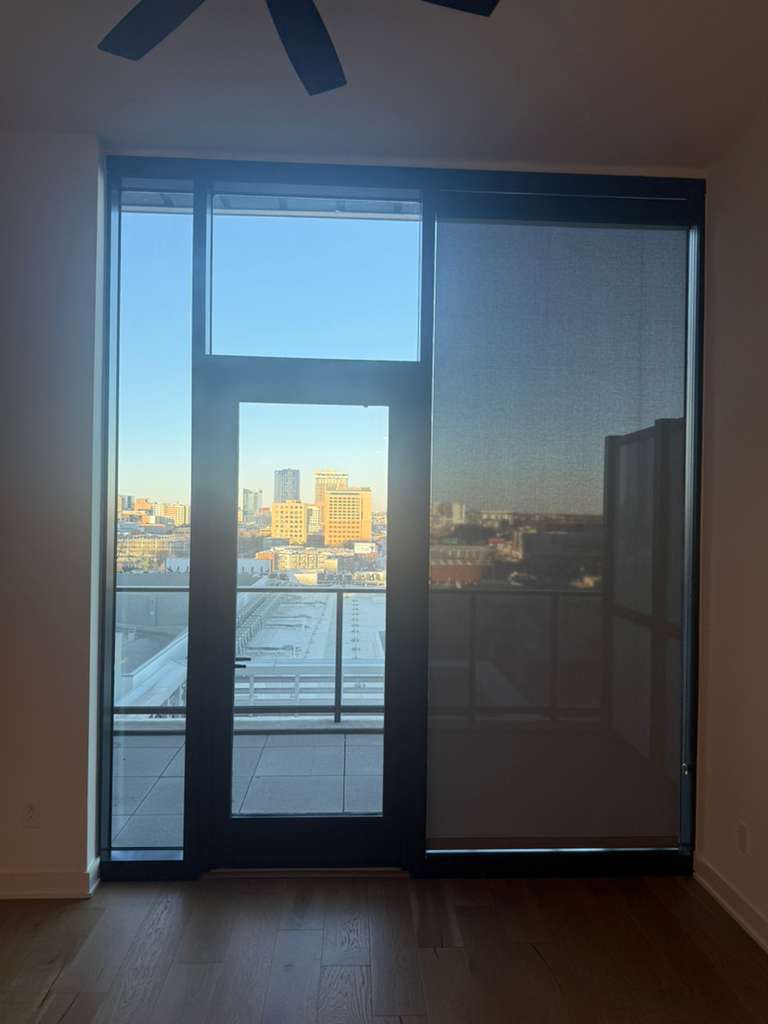 84 East Avenue, Unit 1202 Austin, TX 78701 - Photo 38 of 39 an empty room with a wooden door