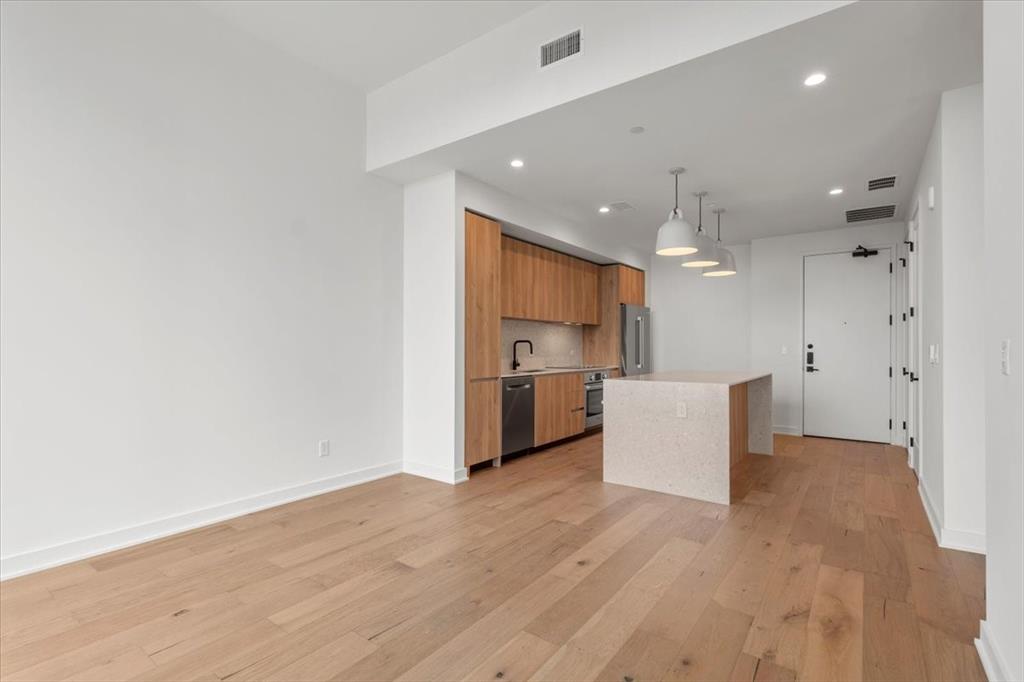 84 East Avenue, Unit 1202 Austin, TX 78701 - Photo 6 of 39 a view of a kitchen with a sink and a refrigerator