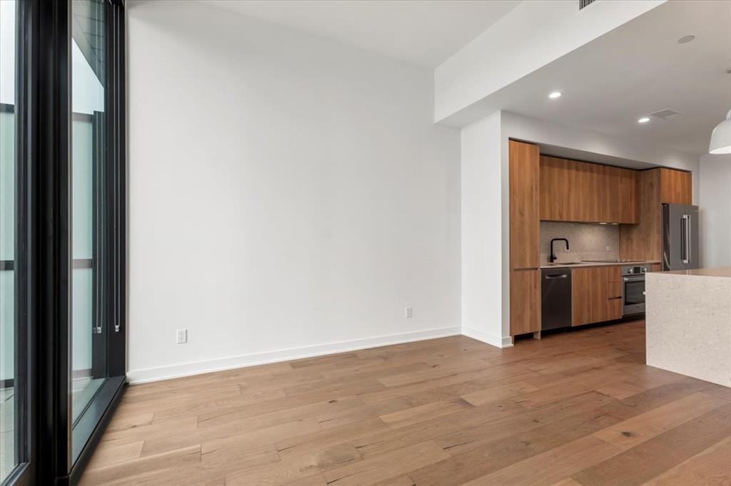 84 East Avenue, Unit 1202 Austin, TX 78701 - Photo 7 of 39 a view of a kitchen with a sink and refrigerator