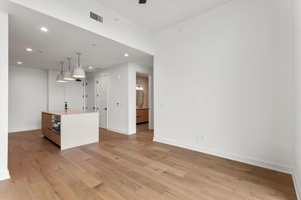 84 East Avenue, Unit 1202 Austin, TX 78701 - Photo 8 of 39 a view of an empty room with kitchen and a sink