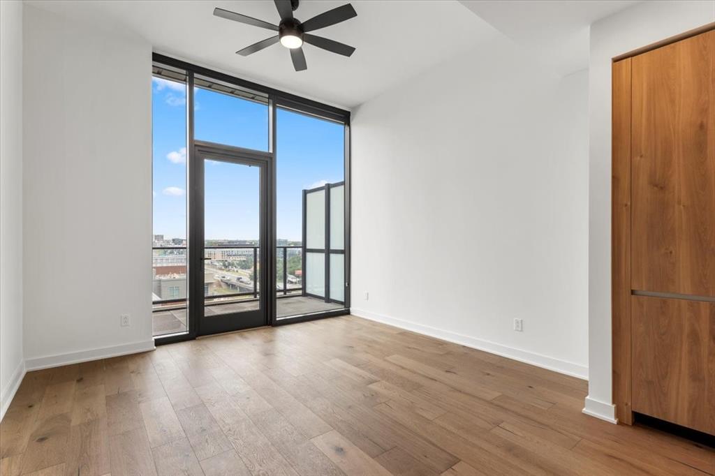 84 East Avenue, Unit 1202 Austin, TX 78701 - Photo 9 of 39 wooden floor in an empty room with a window