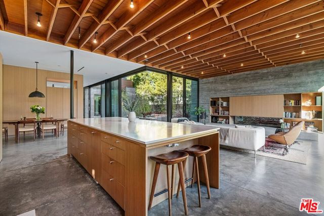 a living room with furniture a flat screen tv and floor to ceiling window