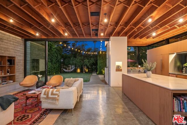 a view of a patio with dining table and chairs potted plants with wooden fence
