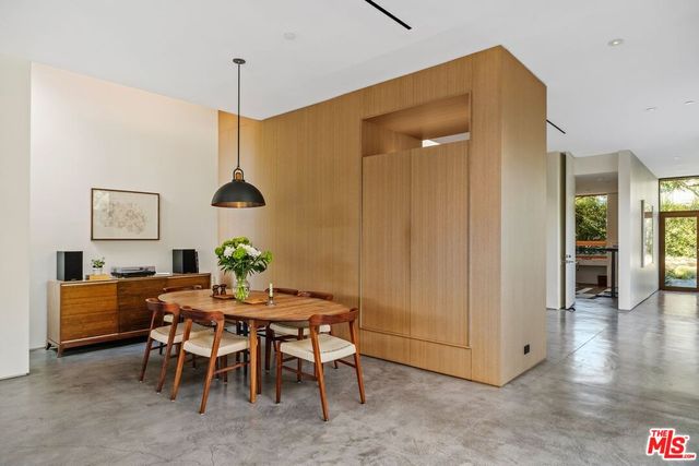a dining room with furniture and a window