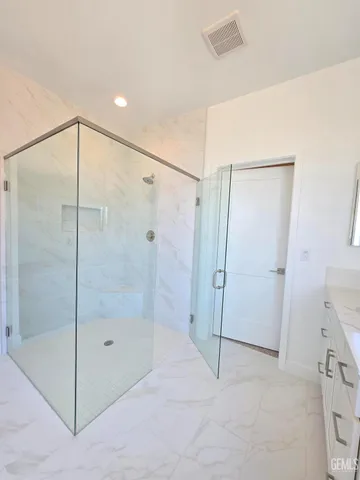 a bathroom with a shower and a glass door