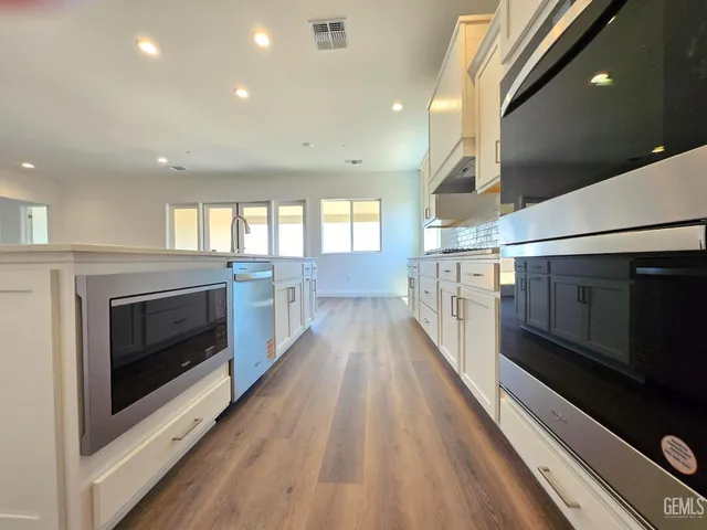 a view of a hallway with wooden floor and a fireplace