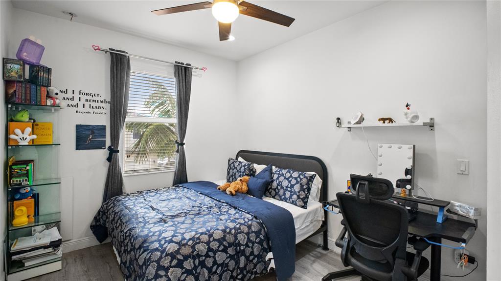 6993 Pines Circle, Unit 6993 Pompano Beach, FL 33073 - Photo 11 of 33 a bedroom with a bed and a window