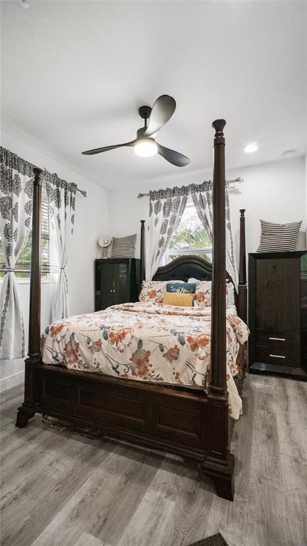 6993 Pines Circle, Unit 6993 Pompano Beach, FL 33073 - Photo 14 of 33 a bed sitting in a bedroom next to a window