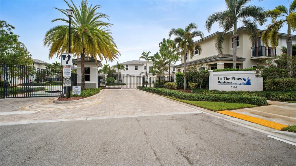 6993 Pines Circle, Unit 6993 Pompano Beach, FL 33073 - Photo 28 of 33 a front view of multiple houses with yard and green space
