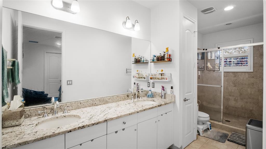 6993 Pines Circle, Unit 6993 Pompano Beach, FL 33073 - Photo 6 of 33 a bathroom with a granite countertop sink a toilet and shower