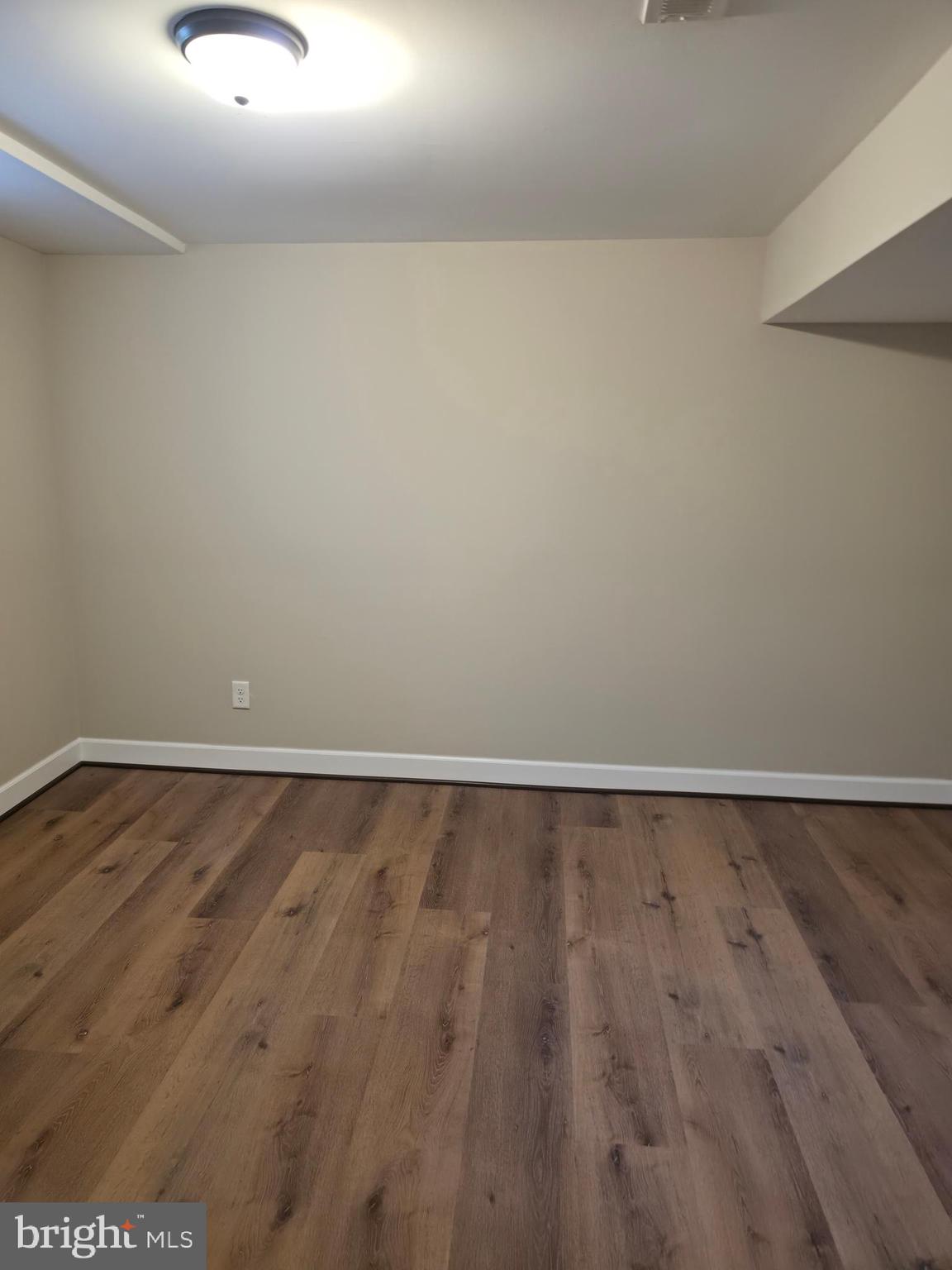 2028 Hillenwood Road Baltimore, MD 21239 - Photo 16 of 18 a view of an empty room with wooden floor