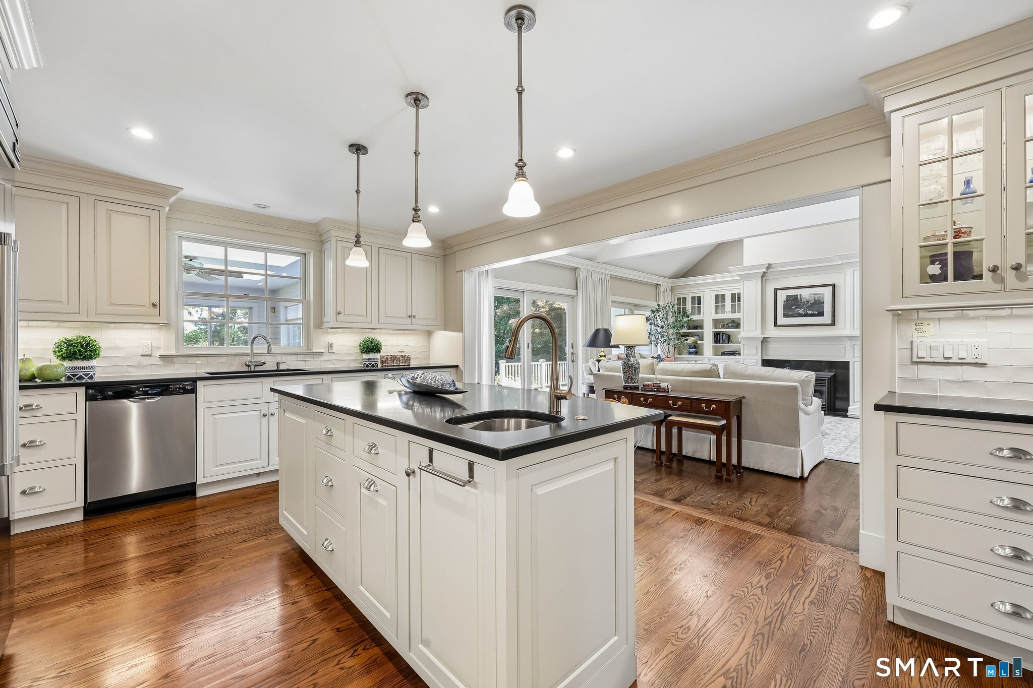 72 Strawberry Hill Road Madison, CT 06443 - Photo 11 of 40 Note the lit glass door cabinetry and pendant lighting over the center island