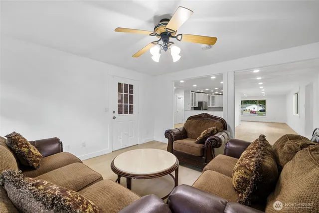 a living room with furniture and a chandelier