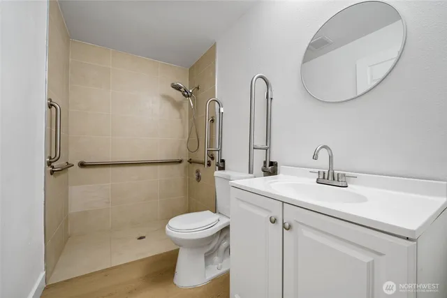 a bathroom with a toilet sink and a mirror