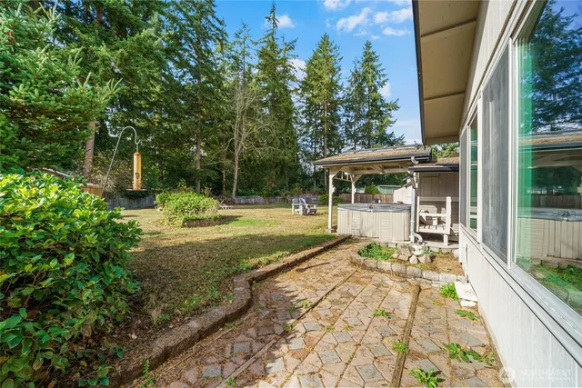 a view of a house with backyard porch and sitting area