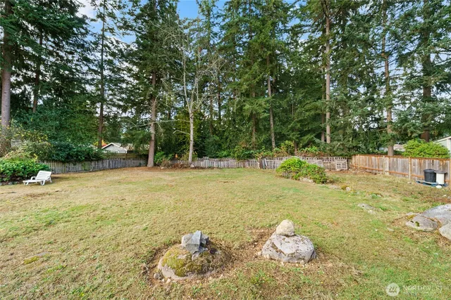 a backyard of a house with table and chairs