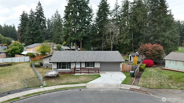 an aerial view of a house with swimming pool and porch
