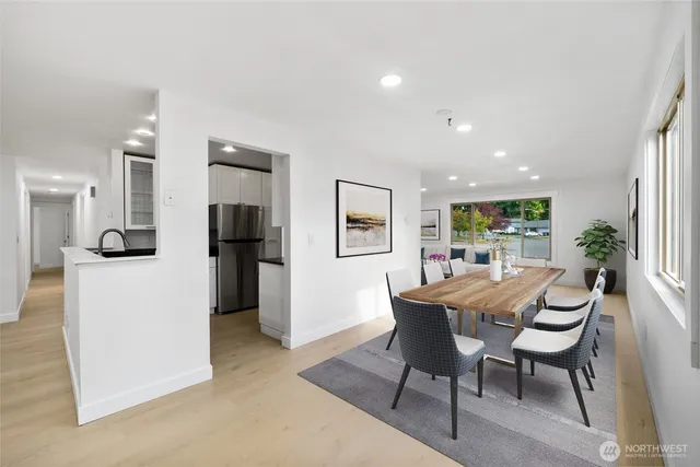 a view of a dining room with furniture and a kitchen