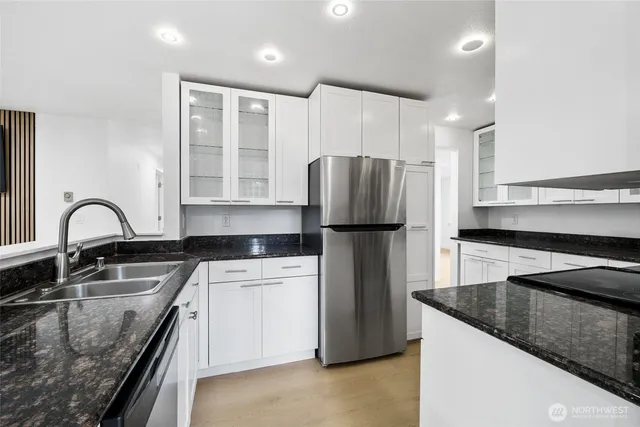 a kitchen with a refrigerator sink and stove