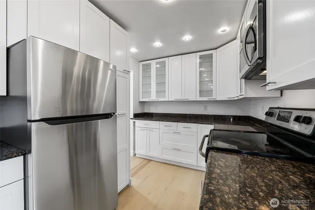 a kitchen with a refrigerator and a sink
