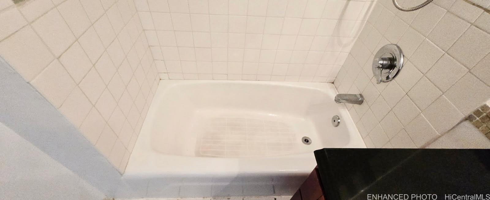 440 Seaside Avenue, Unit 702 Honolulu, HI 96815 - Photo 11 of 14 a bathroom with a bathtub and shower