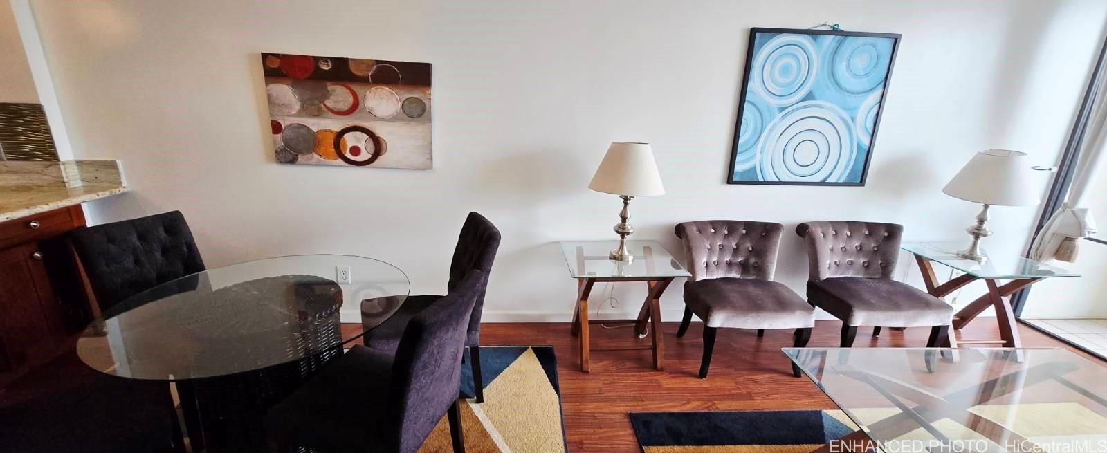 440 Seaside Avenue, Unit 702 Honolulu, HI 96815 - Photo 2 of 14 a view of a dining room with furniture and wooden floor