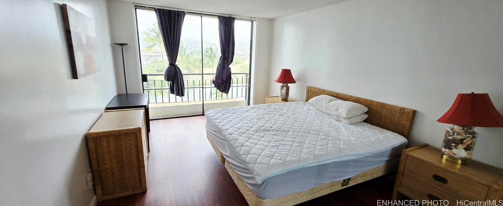 440 Seaside Avenue, Unit 702 Honolulu, HI 96815 - Photo 7 of 14 a living room with furniture and a flat screen tv