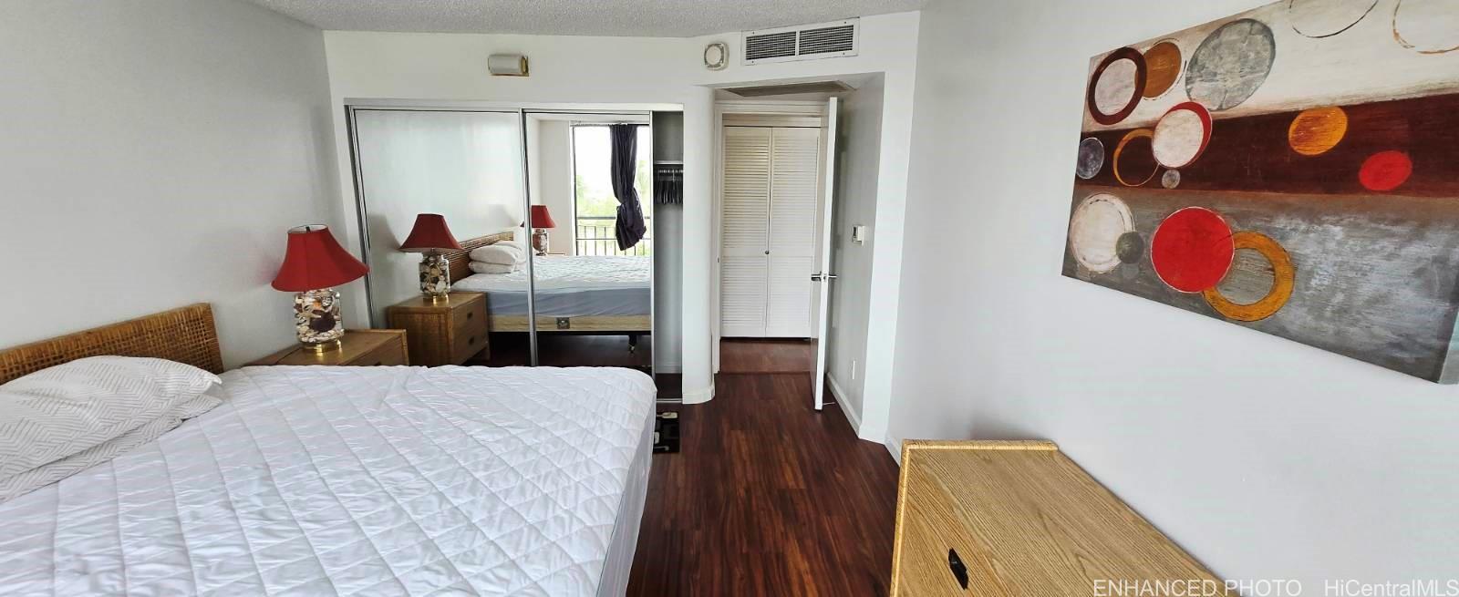 440 Seaside Avenue, Unit 702 Honolulu, HI 96815 - Photo 9 of 14 a living room with furniture and wooden floor