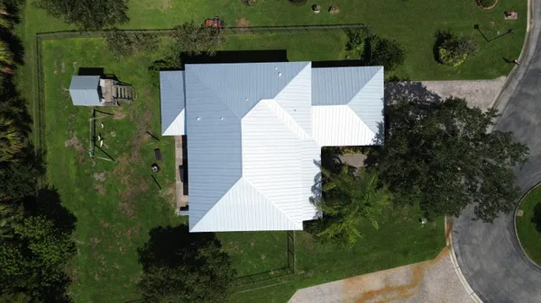 an aerial view of residential houses with outdoor space and river