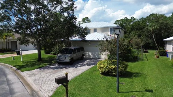 a aerial view of a house with a yard and sitting area