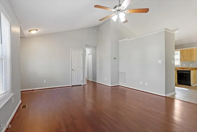 wooden floor in an empty room with a window