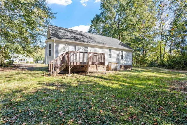 a view of a house with backyard and a patio