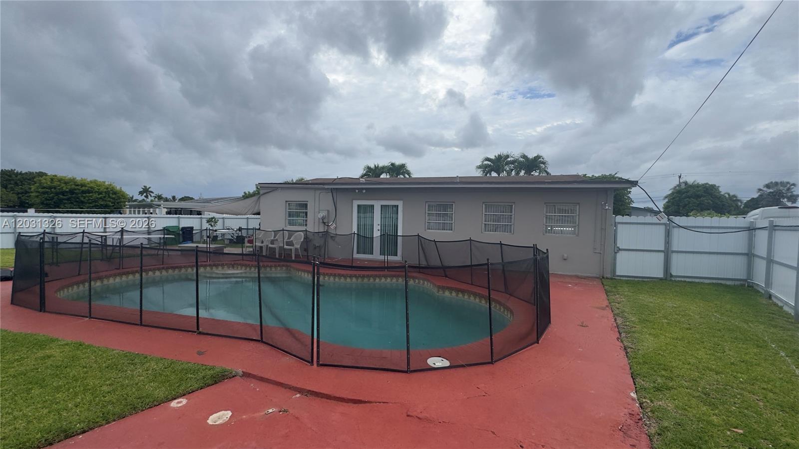 12480 Southwest 189th Street Miami, FL 33177 - Photo 20 of 25 a view of a house with a backyard
