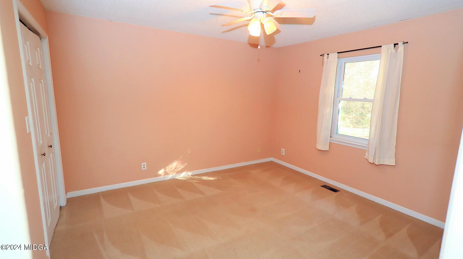 116 Coley Lake Road Macon, GA 31216 - Photo 15 of 22 an empty room with a window and a fan