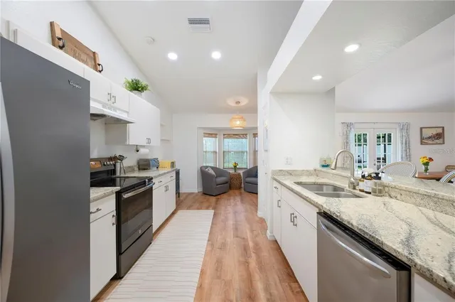 a kitchen with a refrigerator and a stove top oven