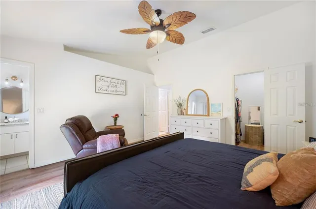 a bathroom with a granite countertop sink toilet mirror and a bathtub