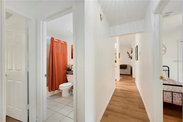 a bedroom with filled bed and a chandelier