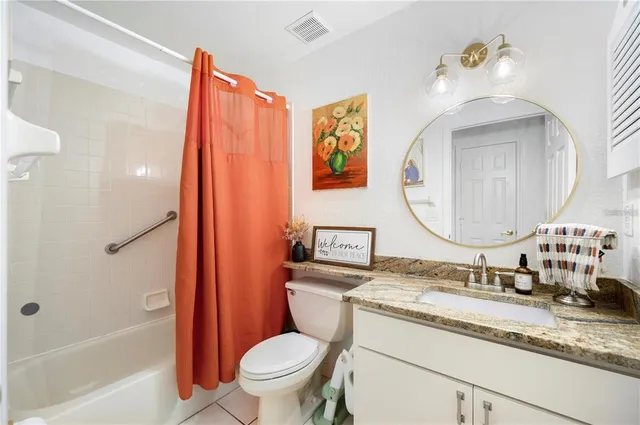 a view of a patio with a table and chairs under an umbrella