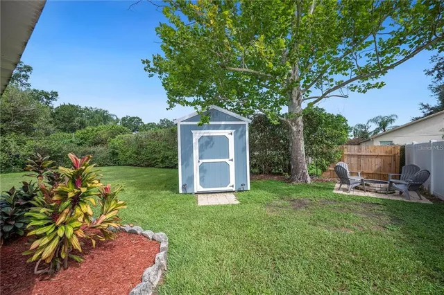 a backyard of a house with table and chairs