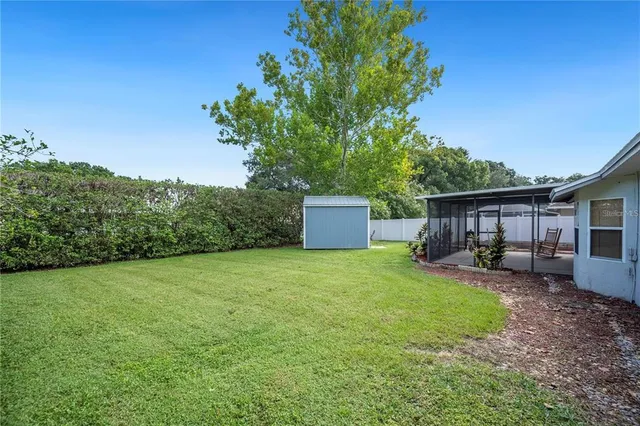 a view of a house with a yard and sitting area