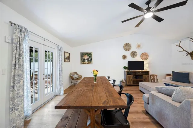 a living room with furniture a flat screen tv and a table