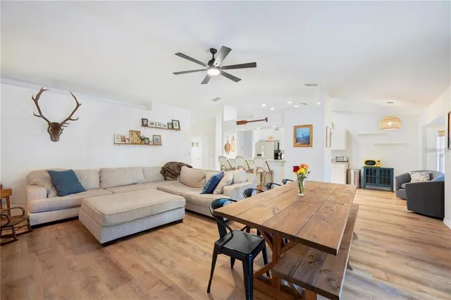 a living room with furniture a ceiling fan and a rug
